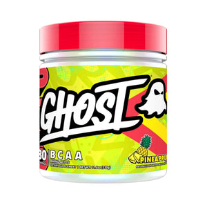 A jar of Ghost BCAA amino acid supplement in Pineapple flavor, featuring a bright red lid and a colorful lime green, yellow, and red label with a ghost logo.