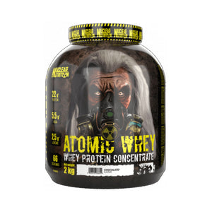 A 2 kg tub of Nuclear Nutrition Atomic Whey Whey Protein Concentrate in Chocolate flavor, featuring a dark, gritty label with a gas mask graphic and yellow text.