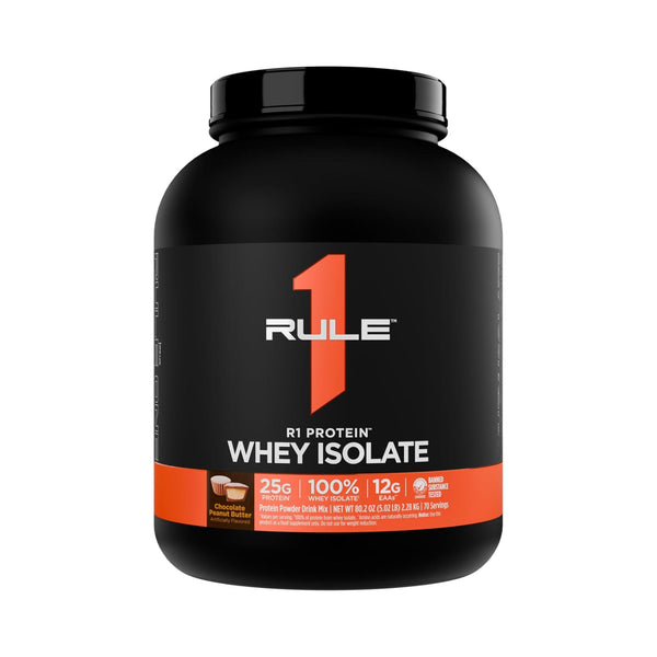 A black tub of R1 Rule Whey Isolate protein powder with a black lid, featuring a black label with a large orange number 1 and white and orange text, on a plain white background.