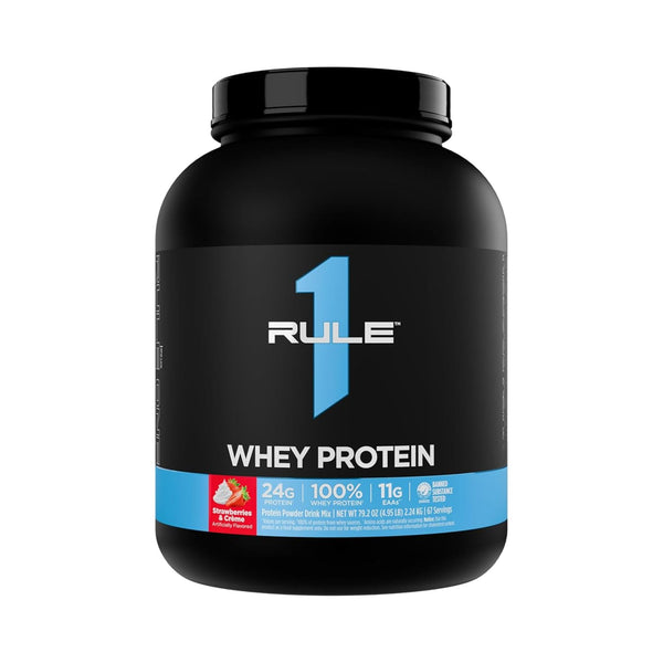 A black tub of RULE 1 Whey Protein powder, featuring a black label with a prominent blue number 1, white text, and a blue band at the bottom indicating 24g protein, 100% whey, and 11g sugar.