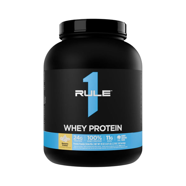 A black tub of RULE 1 Whey Protein powder in Vanilla flavor, featuring a black label with a large blue number 1 and a blue band at the bottom.