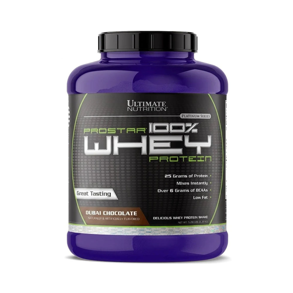A purple plastic tub of Ultimate Nutrition Prostar 100% Whey Protein in Dubai Chocolate flavor, featuring a black and green label with a black screw cap, set against a plain white background.